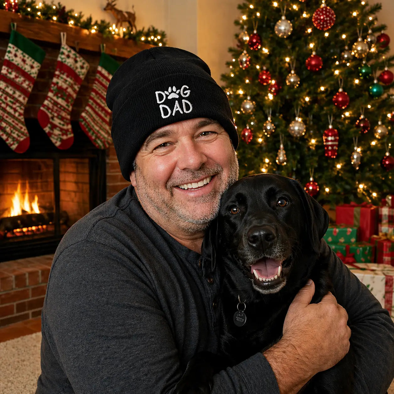Man wearing a dog dad beanie while holding his dog
