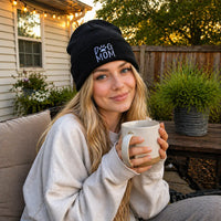 Woman wearing a black dog mom beanie outdoors