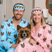 Couple wearing personalized pet sleep masks with their dog